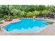 Bright and inviting community pool featuring a spacious deck with lounge chairs and lush landscaping at 19608 Lonesome Pine Dr, Land O Lakes, FL 34638
