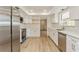 Bright kitchen featuring white cabinets, stainless steel appliances, and quartz countertops at 2146 Waterside Dr, Clearwater, FL 33764