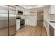 Renovated kitchen with white cabinets, stainless steel appliances, and new flooring at 2146 Waterside Dr, Clearwater, FL 33764