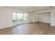 Spacious living room featuring a large bay window, new flooring, and freshly painted walls at 2146 Waterside Dr, Clearwater, FL 33764