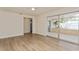 A bright living room with sliding glass door to lanai and a doorway leading to another room at 2146 Waterside Dr, Clearwater, FL 33764