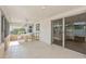 Screened-in patio has tile floors, ceiling fan, dining table, and view of the backyard at 2146 Waterside Dr, Clearwater, FL 33764