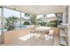 Screened-in patio offers comfortable seating and a view of the lush backyard with a pool at 2146 Waterside Dr, Clearwater, FL 33764