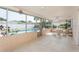 Screened-in patio features a dining table with seating, brick accents, and view of the pool at 2146 Waterside Dr, Clearwater, FL 33764