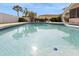 Beautiful in-ground pool surrounded by lush landscaping and fenced-in yard at 2146 Waterside Dr, Clearwater, FL 33764