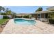 Backyard oasis with a pool, brick pavers, and a covered lanai, perfect for entertaining at 2146 Waterside Dr, Clearwater, FL 33764