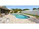Backyard showcases a pristine swimming pool, surrounded by lush landscaping and a white fence at 2146 Waterside Dr, Clearwater, FL 33764