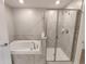 Bathroom featuring a separate tub and a glass-enclosed shower at 23300 Willow Glen Way, Lutz, FL 33549