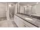 Bathroom featuring double sinks, granite countertops, and tile flooring at 23300 Willow Glen Way, Lutz, FL 33549