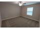 Cozy carpeted bedroom filled with natural light from a bright window at 23300 Willow Glen Way, Lutz, FL 33549