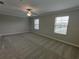 Spacious bedroom with carpet flooring and natural light from two windows at 23300 Willow Glen Way, Lutz, FL 33549