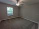 Carpeted bedroom with natural light coming through a window at 23300 Willow Glen Way, Lutz, FL 33549