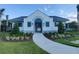 Community clubhouse featuring elegant details, like turquoise shutters and lush landscaping at 23300 Willow Glen Way, Lutz, FL 33549