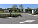 Elegant community entrance with manicured landscaping and a clear view of the neighborhood at 23300 Willow Glen Way, Lutz, FL 33549