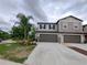 Beautiful townhome featuring neutral paint, well-maintained landscaping and an attached two-car garage at 23300 Willow Glen Way, Lutz, FL 33549