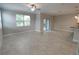 Open living room with tile floors and sliding glass doors at 23300 Willow Glen Way, Lutz, FL 33549