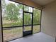 Screened-in back porch overlooking a wooded area at 23300 Willow Glen Way, Lutz, FL 33549
