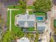Aerial view of a charming home with a private pool, lush landscaping, and a well-maintained yard at 241 72Nd N St, St Petersburg, FL 33710