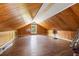 Finished attic space with wood paneling, hardwood floors, and natural light from a window, ideal for a bonus room at 241 72Nd N St, St Petersburg, FL 33710