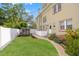 A spacious backyard includes a lush lawn, mature trees, and manicured landscaping at 241 72Nd N St, St Petersburg, FL 33710