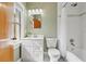 Bright bathroom featuring a white vanity, toilet, and subway-tiled shower and bathtub combination at 241 72Nd N St, St Petersburg, FL 33710