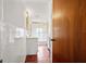 Hall bathroom featuring white fixtures, gold accents, tiled walls and red tile flooring at 241 72Nd N St, St Petersburg, FL 33710
