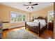 Comfortable bedroom featuring hardwood floors, a ceiling fan, and bright natural light at 241 72Nd N St, St Petersburg, FL 33710