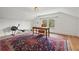 Bonus room features hardwood floors, a large desk and an ornate rug at 241 72Nd N St, St Petersburg, FL 33710
