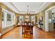 Formal dining room with tray ceiling, hardwood floors, and stylish chandelier lighting at 241 72Nd N St, St Petersburg, FL 33710
