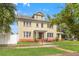 Charming two-story home with a well-manicured lawn and brick accents, showcasing classic curb appeal at 241 72Nd N St, St Petersburg, FL 33710