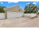 A three-car garage with white doors and a private driveway offers ample parking space at 241 72Nd N St, St Petersburg, FL 33710