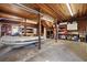 Spacious garage interior featuring a boat, wooden ceiling, and ample storage solutions, perfect for hobbyists at 241 72Nd N St, St Petersburg, FL 33710