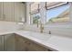 Bright kitchen with a white farmhouse sink, light countertops, and updated cabinets at 241 72Nd N St, St Petersburg, FL 33710