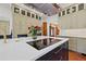 Open kitchen featuring an island with a cooktop and a stunning arrangement of fresh cut red roses at 241 72Nd N St, St Petersburg, FL 33710