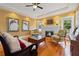 Cozy living room featuring a white brick fireplace, hardwood floors, and abundant natural light at 241 72Nd N St, St Petersburg, FL 33710