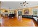 Spacious living room featuring hardwood floors, a fireplace, and ample seating with neutral paint at 241 72Nd N St, St Petersburg, FL 33710
