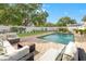 Relaxing outdoor seating surrounds a private pool and patio, perfect for enjoying the backyard oasis at 241 72Nd N St, St Petersburg, FL 33710