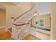 Elegant staircase with white railings, wood steps and landing, leading to the upper level at 241 72Nd N St, St Petersburg, FL 33710