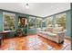 Sunroom featuring neutral furniture, terra cotta tile floor, large windows and verdant houseplants at 241 72Nd N St, St Petersburg, FL 33710