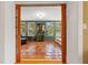 View into the sunroom with terra cotta tile, soft natural light, neutral furniture and verdant houseplants at 241 72Nd N St, St Petersburg, FL 33710