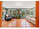 Sunroom with terra cotta tile, soft natural light, neutral furniture and verdant houseplants at 241 72Nd N St, St Petersburg, FL 33710