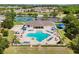 Aerial view of a resort style pool, lounge chairs, and surrounding community at 2641 Big Pine Dr, Holiday, FL 34691