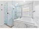 This bathroom features a jacuzzi tub and shower both lined with marble at 2641 Big Pine Dr, Holiday, FL 34691
