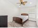 Neutral bedroom with a wooden bed frame, wood flooring, and a ceiling fan at 2641 Big Pine Dr, Holiday, FL 34691