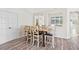 Bright dining area boasts wood floors and tall chairs around the table, perfect for Gathering meals at 2641 Big Pine Dr, Holiday, FL 34691