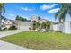 Well-maintained single-story home with a two-car garage, lush lawn, and fenced yard at 2641 Big Pine Dr, Holiday, FL 34691