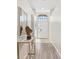 Hallway featuring arched entryways, tile flooring transitioning to wood, and a view of the front door at 2641 Big Pine Dr, Holiday, FL 34691