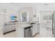 Open concept kitchen with white cabinets, stainless appliances, and seamless flow to the living area at 2641 Big Pine Dr, Holiday, FL 34691