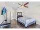 This main bedroom features tile floors, a ceiling fan and light neutral colored walls at 2641 Big Pine Dr, Holiday, FL 34691