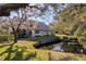 A tranquil backyard featuring a small pond and views of the home's rear exterior at 2870 Rampart Cir, Clearwater, FL 33761